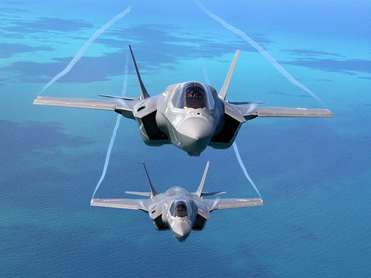 A UK F-35 flies above a USMC F-35 over the UK in 2016